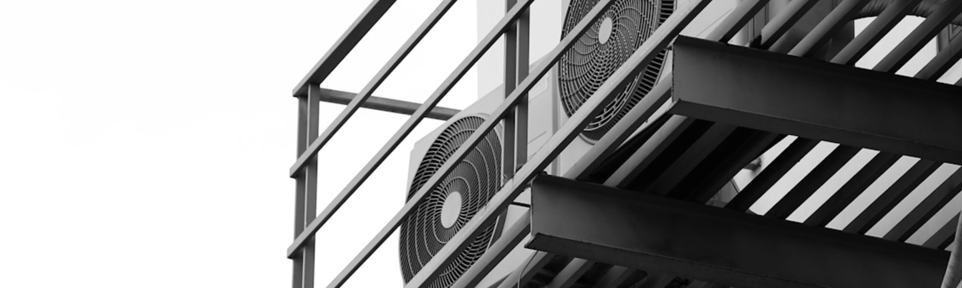 a black and white photo of a clock on a building